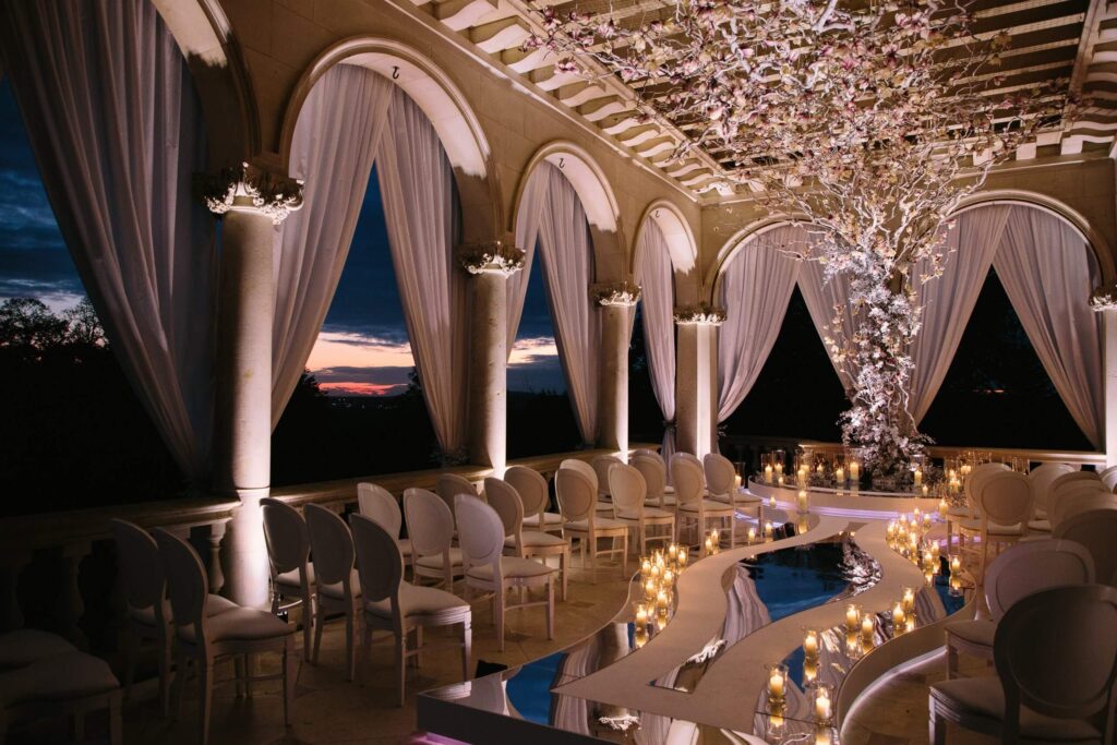 Wedding ceremony setup with warm white uplighting
