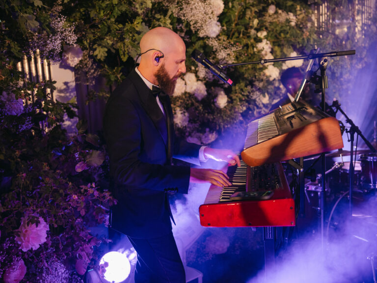 Keyboardist in the live band with stage lighting