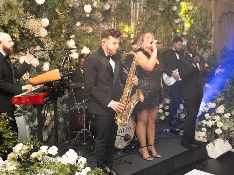 Live band performing on stage with microphones and IEMs