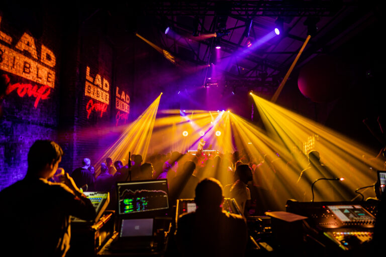 Front of house view of stage with yellow lighting