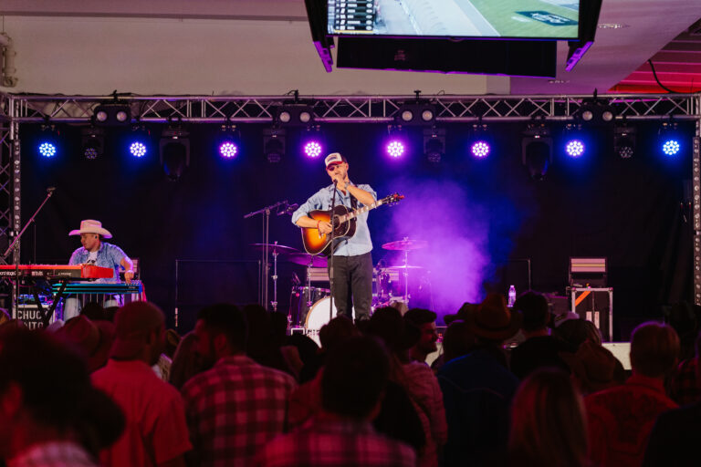 Country singer on stage with purple lighting