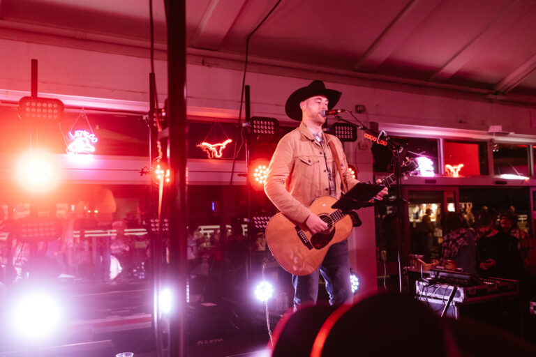 Country singer performing with stage lighting