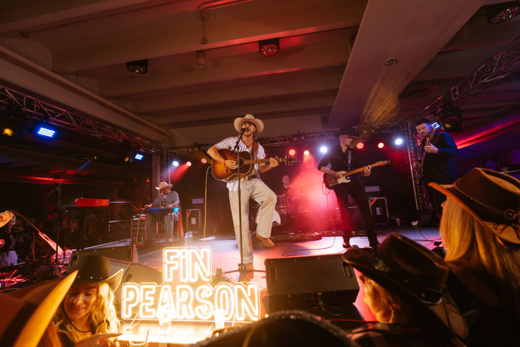 Country singer performing with stage lighting