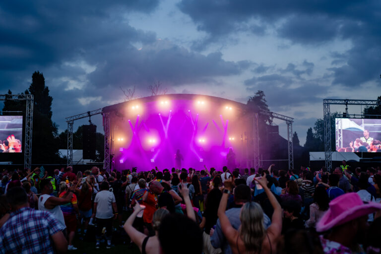 Night time shot of crowd in front of main stage lit up